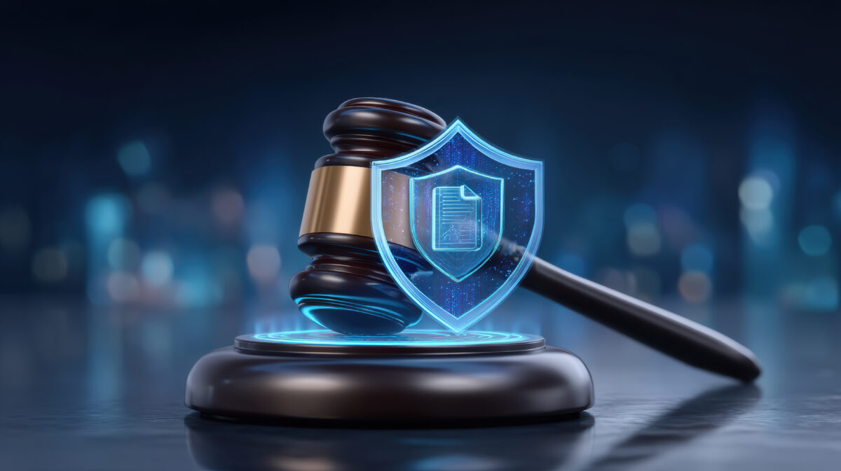 Serious cyber security law concept with gavel and shield protecting online digital data Serious cyber security law concept with gavel and shield protecting online digital data.